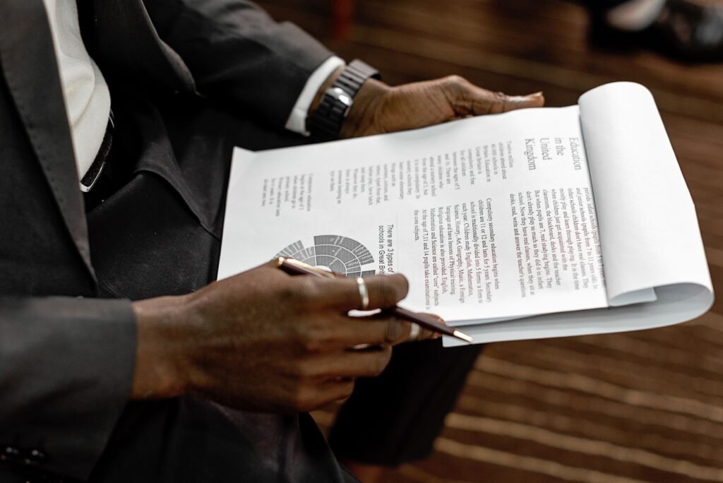 How to Choose the Right Property Investment in Abuja Business professional reviewing financial documents with charts and graphs during a meeting.
